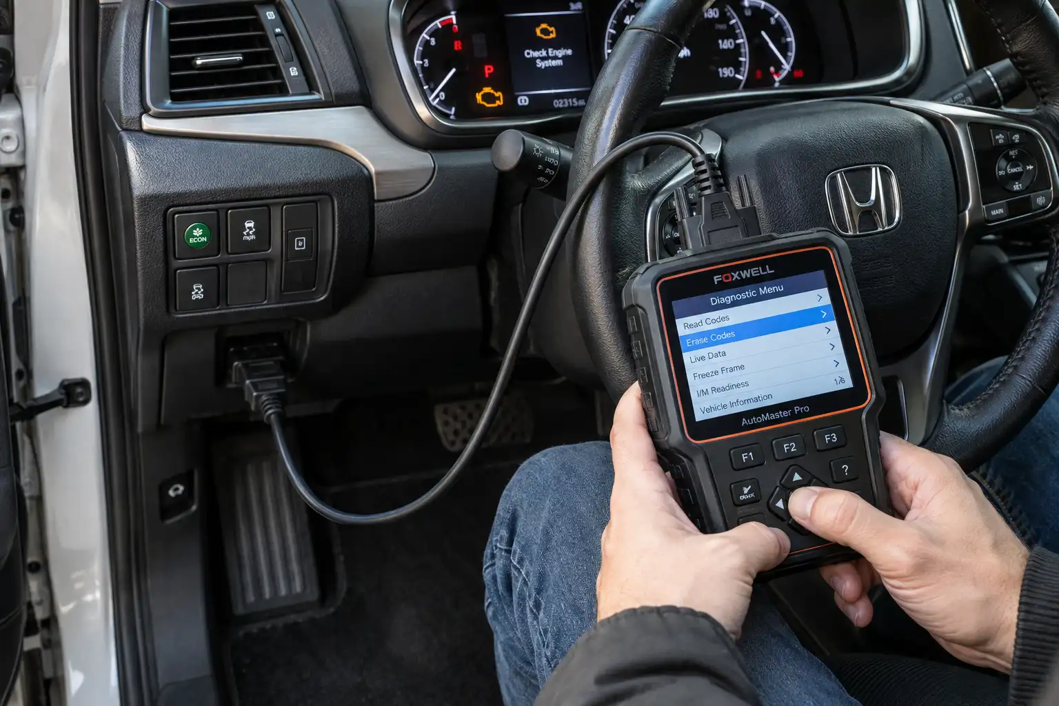 A man using an OBD2 scanner to select the erase codes option while the check engine light is illuminated on the dashboard.